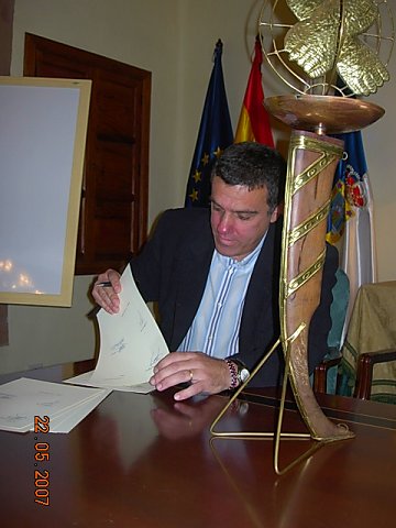 El presidente firma el acuerdo.